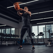 Person performing powerful kettlebell swing