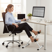 Person using pedal exerciser under desk